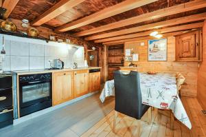 a kitchen with a table and a stove at Chalet Alpage in Les Crosets