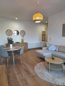 a living room with a couch and a table at Apartmán Stará Tržnica in Trenčín