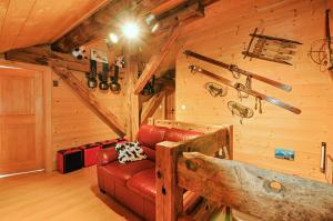 a living room with a red couch in a cabin at Chalet Alpage in Les Crosets +36 photos