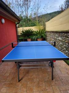 a blue ping pong table sitting on a patio at VILLA BICE in Versilia - Piscina Privata - Toscana in Pietrasanta