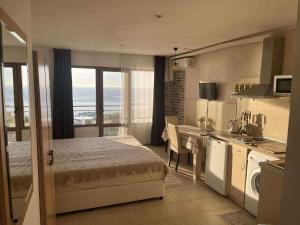 a bedroom with a bed and a kitchen with a balcony at Only Adults- RAI in Golden Sands