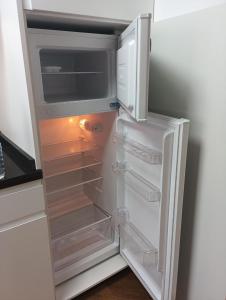 an empty refrigerator with its door open in a kitchen at Apartamento rural Rubí in El Torno