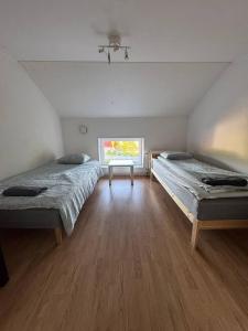 a room with two beds and a window at Workers Stay - Worker Accommodation Torslanda - Volvo - Sweden in Gothenburg