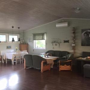 a living room with a couch and a table at Guesthouse in Hellosan in Vestvågøya