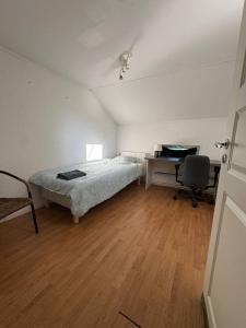 a bedroom with a bed and a desk with a computer at Workers Stay - Worker Accommodation Torslanda - Volvo - Sweden in Gothenburg +1 photo