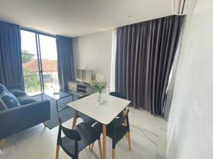 a living room with a table and chairs and a couch at White Cube House in Nathon Bay