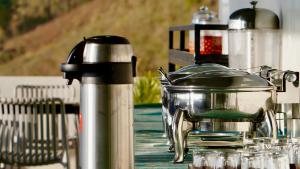a table with a tea pot on top of it at Clouds end Resorts Munnar in Jāmb