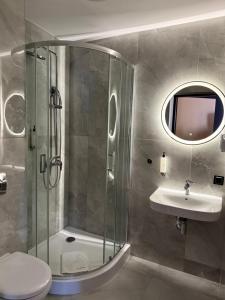 a bathroom with a shower and a toilet and a sink at Hotel Martex in Płońsk +45 photos