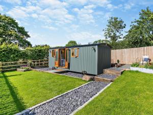 a tiny house in a yard with a fence at 1 Bed in Cheltenham oc-95422 in Cheltenham
