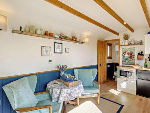 a living room with a table and chairs and a kitchen at 1 Bed in Cheltenham oc-95422 in Cheltenham