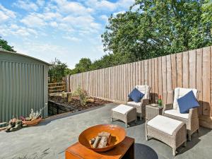 a patio with two chairs and a table and a fence at 1 Bed in Cheltenham oc-95422 in Cheltenham +13 photos