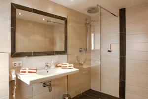 a bathroom with a sink and a shower at Amontanara in Nauders +61 photos