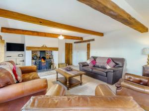 a living room with leather furniture and a fireplace at 4 Bed in Wigton oc-79563 in Calvo
