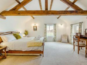 a bedroom with a large bed and a desk at 4 Bed in Wigton oc-79563 in Calvo