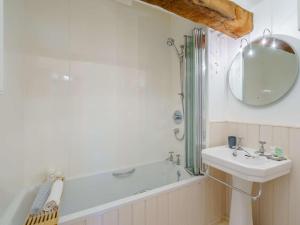 a bathroom with a sink and a tub and a mirror at 4 Bed in Wigton oc-79563 in Calvo +18 photos