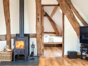 a wood stove in a room with a bedroom at 3 Bed in Worcester oc-41983 in Broadwas