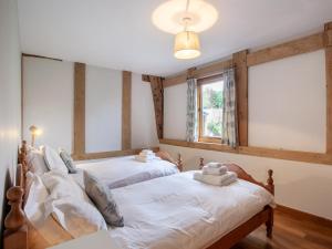 two beds in a room with two windows at 3 Bed in Worcester oc-41983 in Broadwas