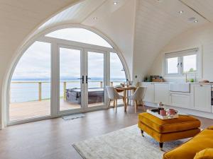 an arched kitchen and dining room with a view of the ocean at 1 Bed in Tain oc-96065 in Nigg