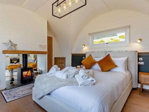 a bedroom with a large white bed with towels on it at 1 Bed in Tain oc-96065 in Nigg