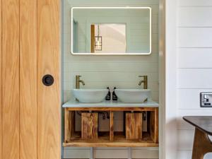 a bathroom with two sinks and a mirror at 1 Bed in Tain oc-96065 in Nigg +21 photos