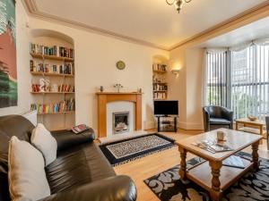 a living room with a couch and a fireplace at 6 Bed in Tenby oc-fb220 in Tenby