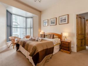 a bedroom with a large bed and a window at 6 Bed in Tenby oc-fb220 in Tenby