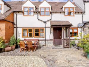 a house with a table and chairs in front of it at 2 Bed in Evesham oc-89476 in Bretforton