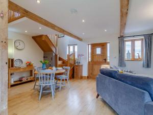 a living room with a blue couch and a table at 1 Bed in Gloucester oc-60276 in Tirley
