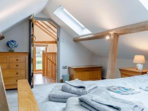 a bedroom with a bed with towels on it at 1 Bed in Gloucester oc-60276 in Tirley