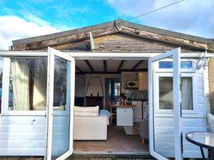 a white caravan with a door open to a kitchen at 2 Bed in Galmpton oc-bx008 in Galmpton-on-the-Dart