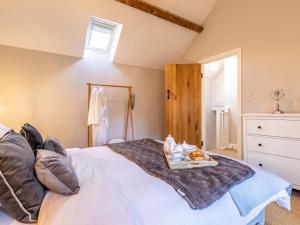 a bedroom with a large white bed with a window at 1 Bed in Moreton -in- Marsh oc-53420 in Blockley