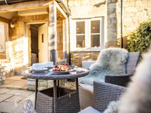 a table with a bowl of fruit on a patio at 1 Bed in Moreton -in- Marsh oc-53420 in Blockley