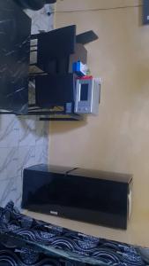 a flat screen tv sitting on a wall at Secka Apartment in Sukuta +4 photos