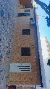 a tall brick building with a door on it at Secka Apartment in Sukuta