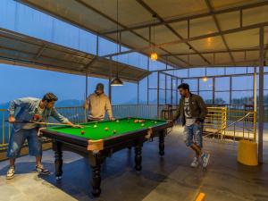 a group of men playing a game of snooker at The Hosteller Bam Vagamon in Vagamon +19 photos