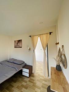 a bedroom with a bed and a large window at Homestay 234 Dốc Lết in Ba Ha +7 photos