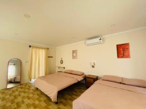 a hotel room with two beds and a window at Homestay 234 Dốc Lết in Ba Ha