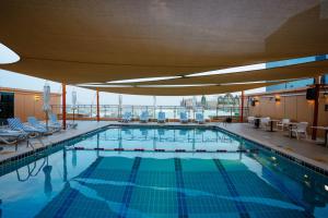 a large swimming pool on a cruise ship at Sheraton Khalidiya Hotel in Abu Dhabi