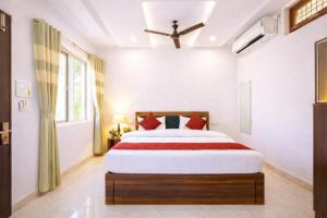 a bedroom with a large bed with red pillows at Shree Sita Sadan in Ayodhya