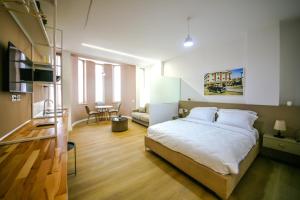 a bedroom with a bed and a living room at Denis Studios Durres in Durrës
