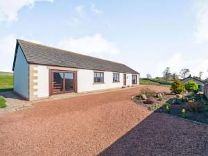 a house with a gravel driveway in front of it at 3 Bed in Berwick-upon-tweed oc-87777 in Lamberton