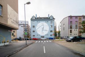 a large clock on the side of a building at Appartamento Nivy con posto auto in Bratislava +13 photos
