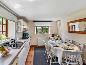 a kitchen with a table and chairs in a room at 3 Bed in Buckingham oc-94701 in Finmere