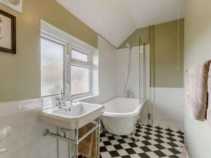 a bathroom with a white tub and a sink at 3 Bed in Malvern oc-90775 in Mathon +31 photos