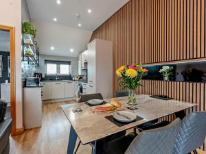 a kitchen with a table with a vase of flowers at 2 Bed in Castle Douglas oc-59637 in Castle Douglas