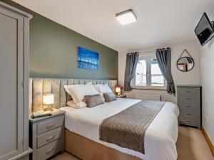 a bedroom with a large bed and a window at 2 Bed in Castle Douglas oc-59637 in Castle Douglas