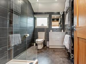 a bathroom with a toilet and a glass shower at 2 Bed in Castle Douglas oc-59637 in Castle Douglas