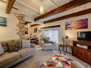 a living room with a couch and a flat screen tv at 2 Bed in Carnforth oc-90530 in Beetham