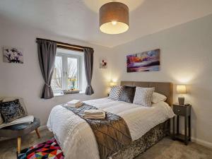 a bedroom with a bed and a window at 2 Bed in Carnforth oc-90530 in Beetham