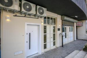 a building with two air conditioners on the side of it at Denis Studios Durres in Durrës